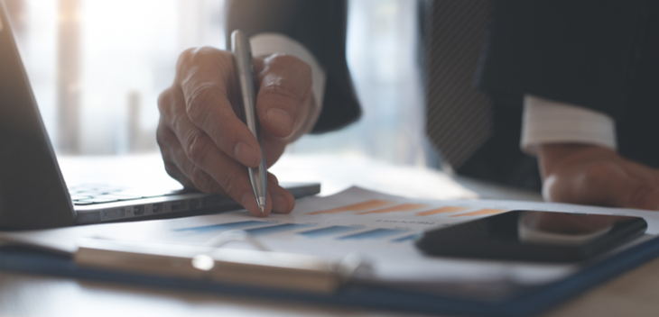 Man in suit signing papers