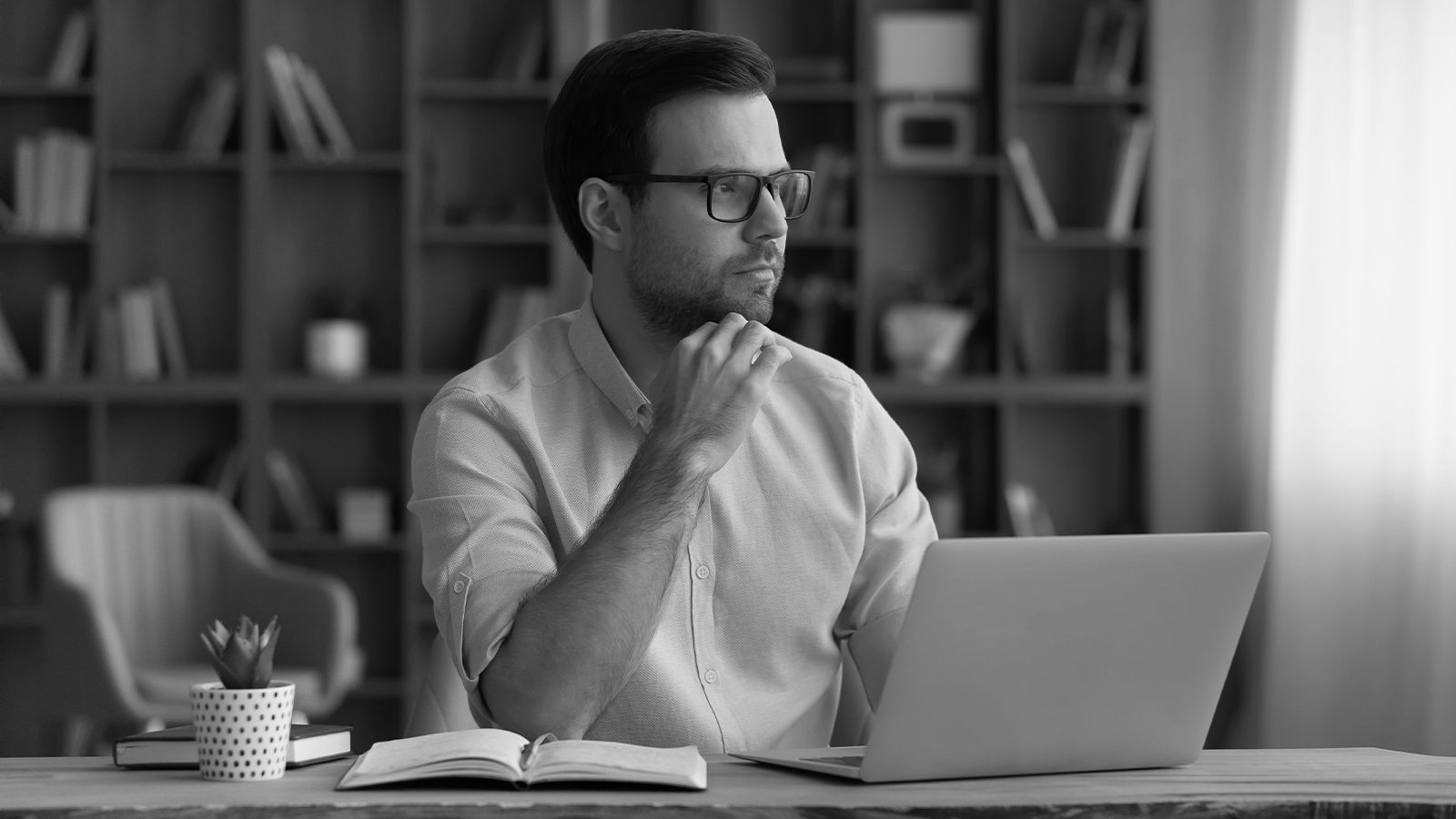 Man looking at laptop concerned about cyber threats