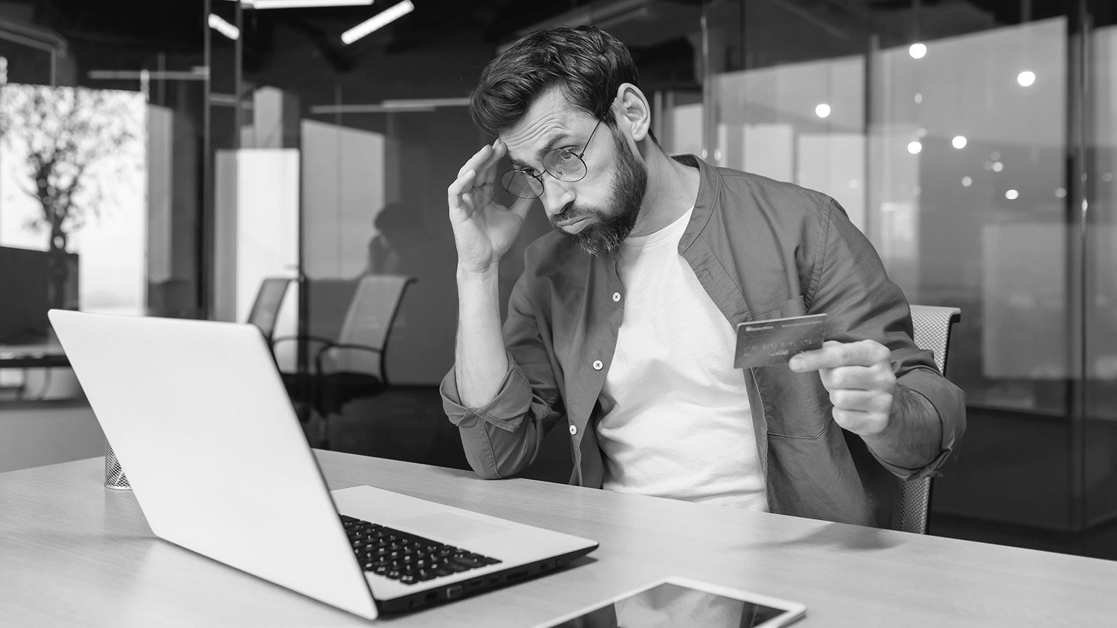 Man frustrated looking at laptop