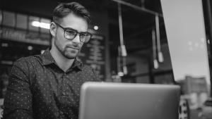 man with glasses on laptop