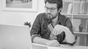 Man with credit card looking at laptop